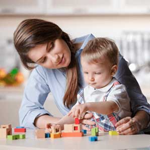 Parent playing with child with toys