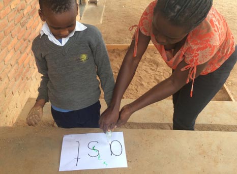 Photo of teaching boy to write